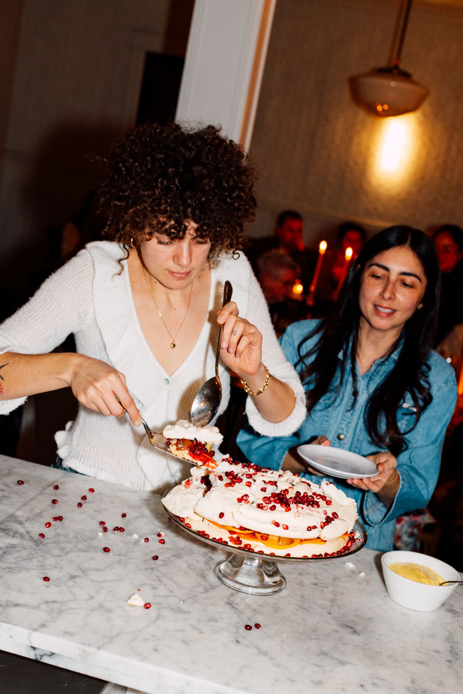 Image may contain People Person Curly Hair Hair Face Head Adult Birthday Cake Cake Cream Dessert and Food