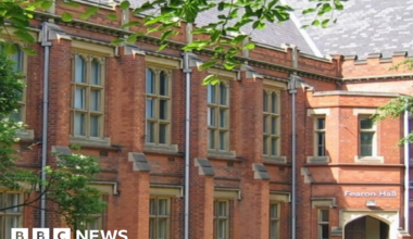 The exterior of Fearon Hall, a red-brick two-storey building with large stone framed windows.