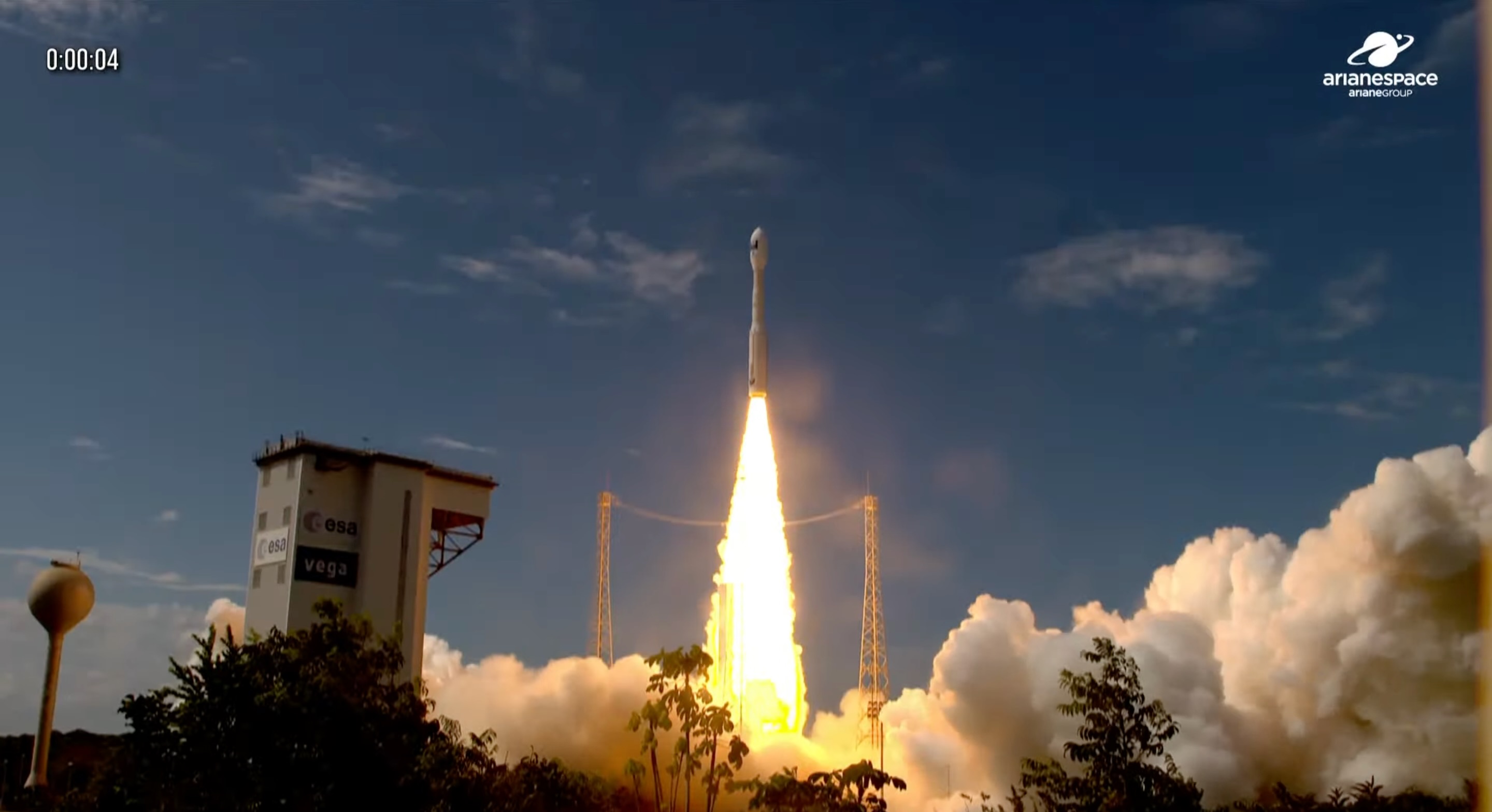 a white rocket launches into a blue sky