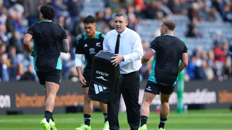All Blacks assistant coach Jason Holland helps during the team's warm-up for their win over Scotland in Edinburgh last month.