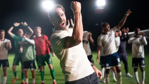 Leftbank Pictures/Dan Fearnan Joseph Fiennes as England manager Gareth Southgate, giving a celebratory fist gesture