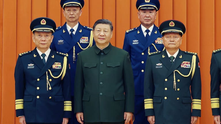 Chinese President Xi Jinping, also chairman of the Central Military Commission (CMC), front row second from left, poses with other military officers