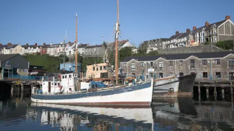 Geography Photos Boats and houses Milford Haven harbor, Pembrokeshire, Wales.