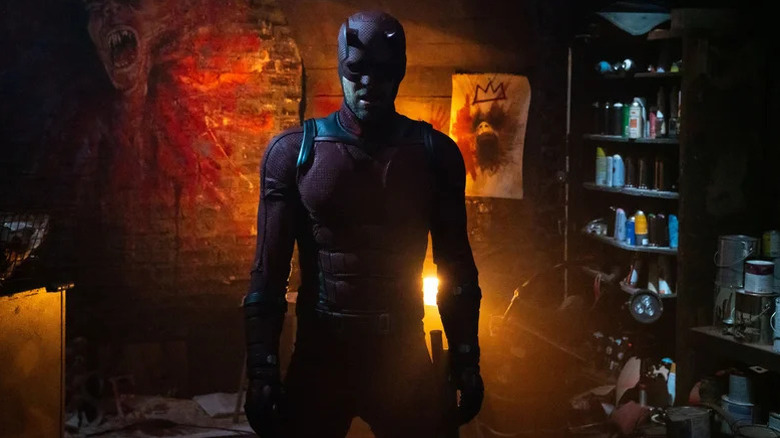 Daredevil (Charlie Cox) stands in Blindspot's darkened art studio in Daredevil: Born Again