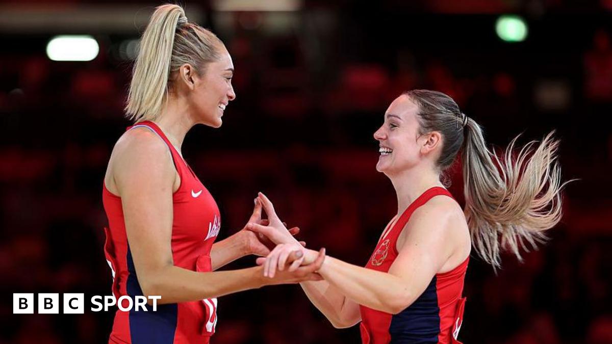 Natalie Metcalf and Helen Housby hold hands and celebrate