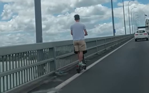 E-scooter rider clings to white line on risky commute over Akl Harbour Bridge