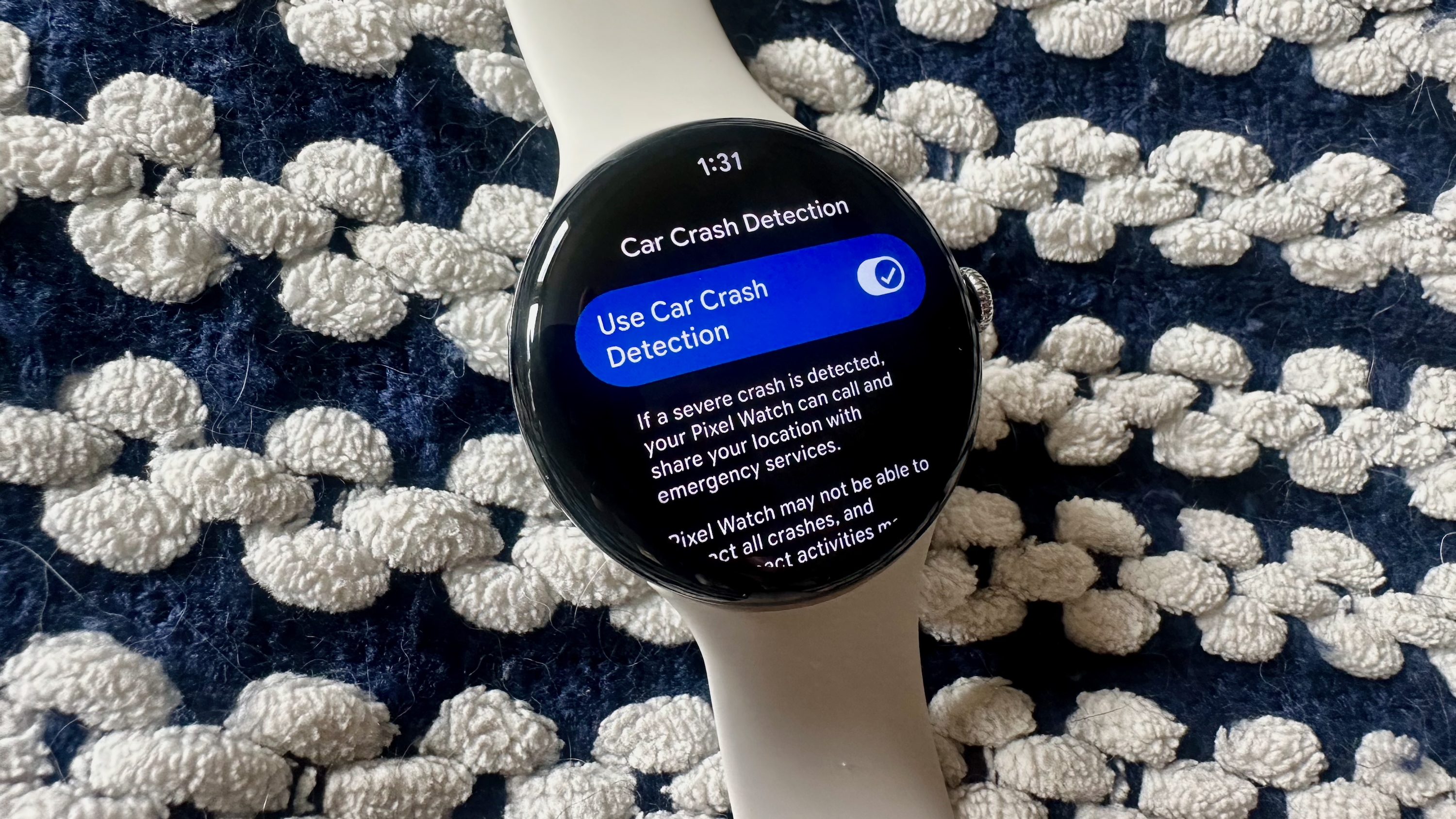 A photo of the Google Pixel Watch 4 showing the Car Crash Detection settings option.