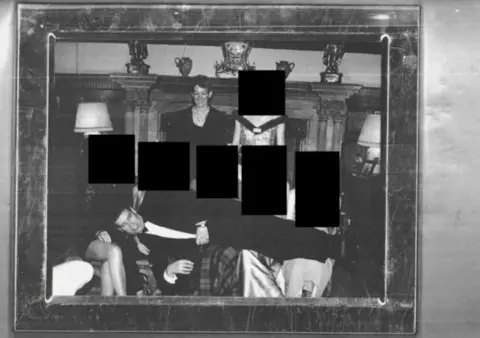 US Department of Justice A black and white image showing Andrew lying across the laps of women