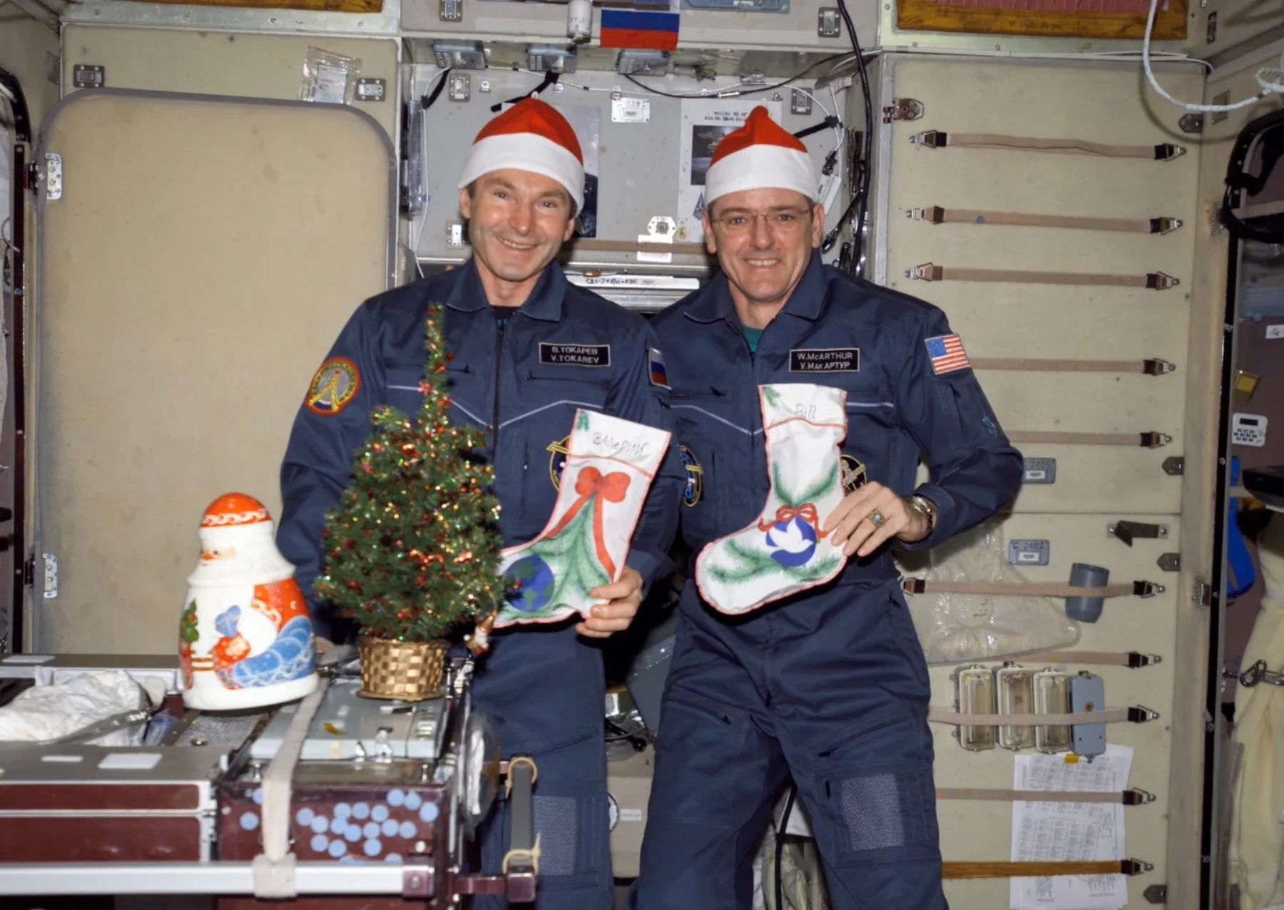 two astronauts posing with christmas stockings