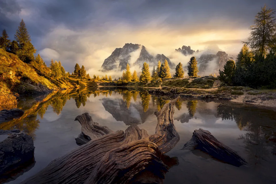 misty lake with mountains and lake and evergreen trees