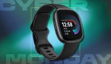 Fitbit Versa 4 black smartwatch on green background with text: Cyber Monday