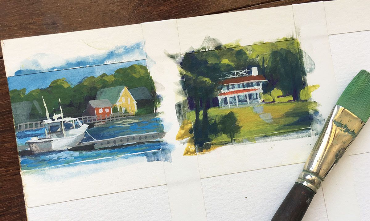 Two small landscape paintings and a paintbrush covered in paint