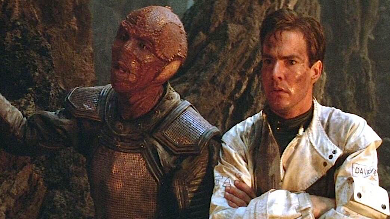 A reptilian alien and a human on a hostile planet
