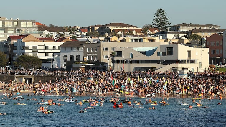 Members of the Bondi community pay their respects during a reflection before paddling out to honour victims, survivors and first responders of the December 14th Bondi Attacks on December 19, 2025