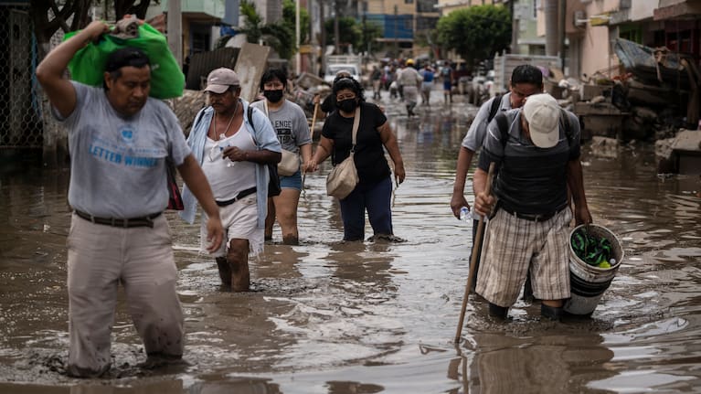 People traverse a flooded street in Poza Rica, Veracruz state, Mexico.