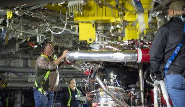 crew installing the first new production RS-25 engine on the Fred Haise Test Stand