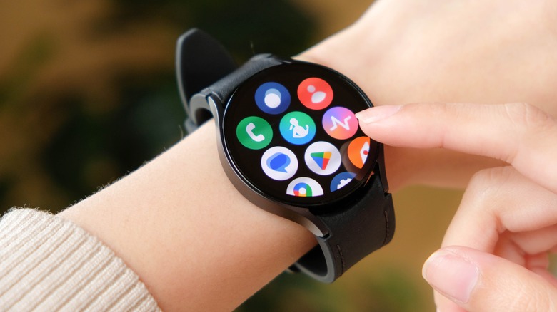A smartwatch with multiple app icons displayed on the screen