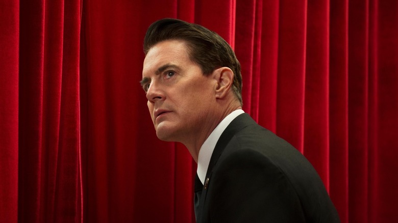 Dale Cooper (Kyle MacLachlan) stares up from the red-curtained Red Room in Twin Peaks: The Return