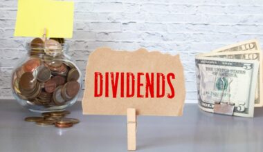 The word dividends held up between a jar of coins and paper money.