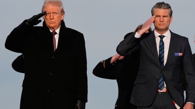 US President Donald Trump and Defence Secretary Pete Hegseth salute during a casualty return for Iowa National Guard soldiers