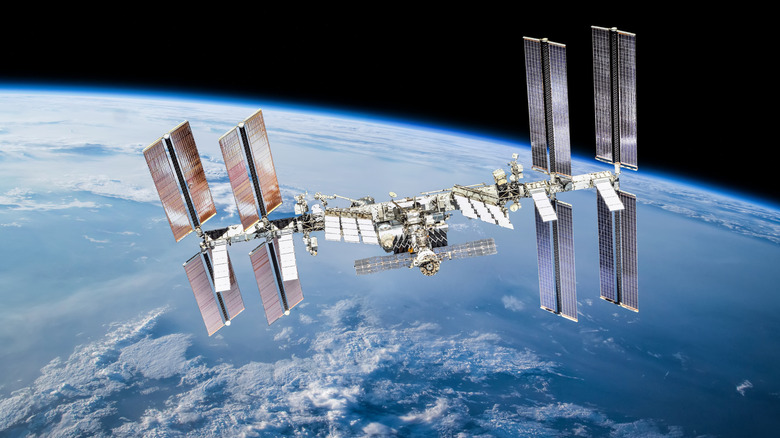 International Space Station in orbit with Earth behind.