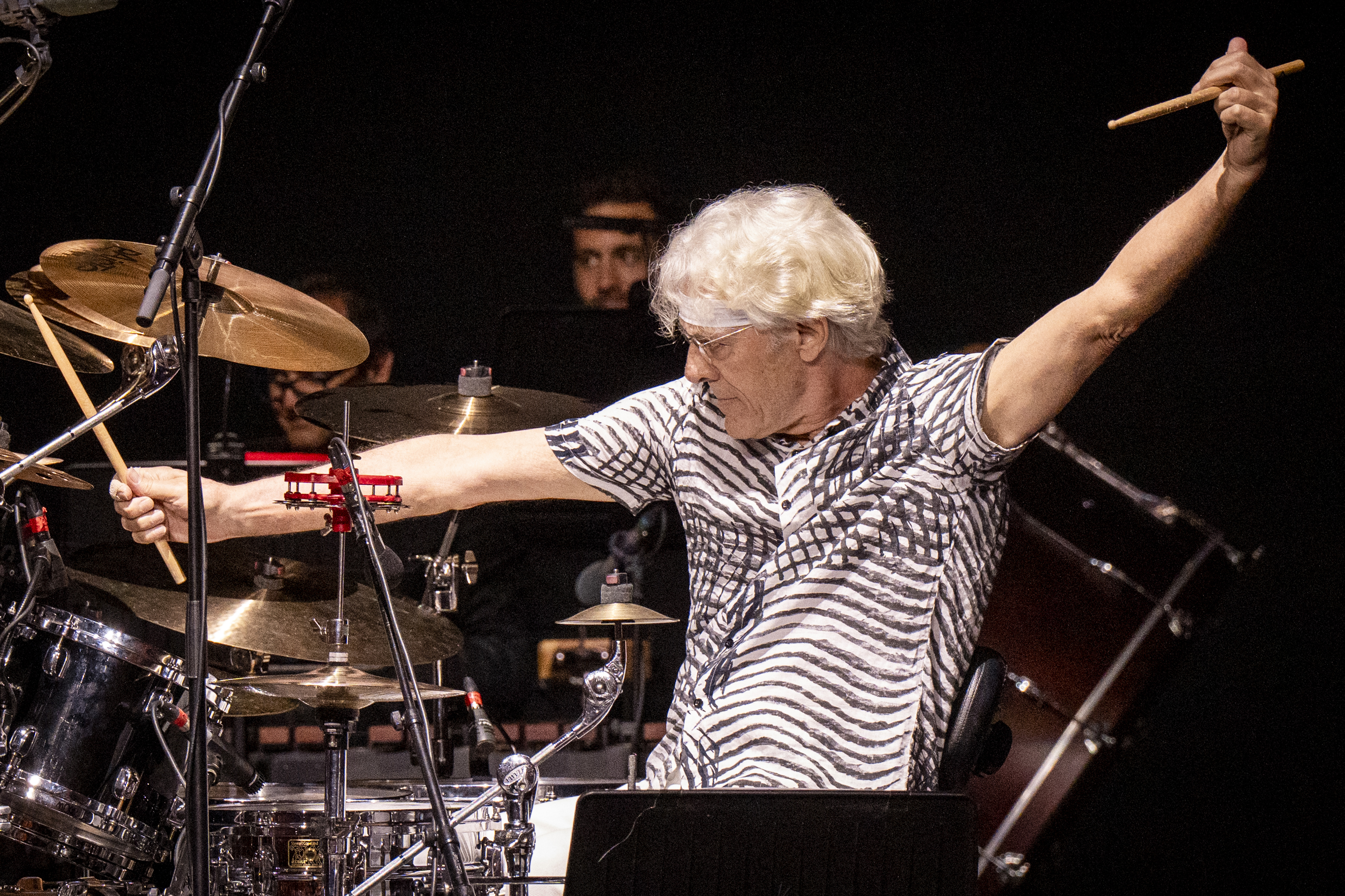 Stewart Copeland performing at a concert.