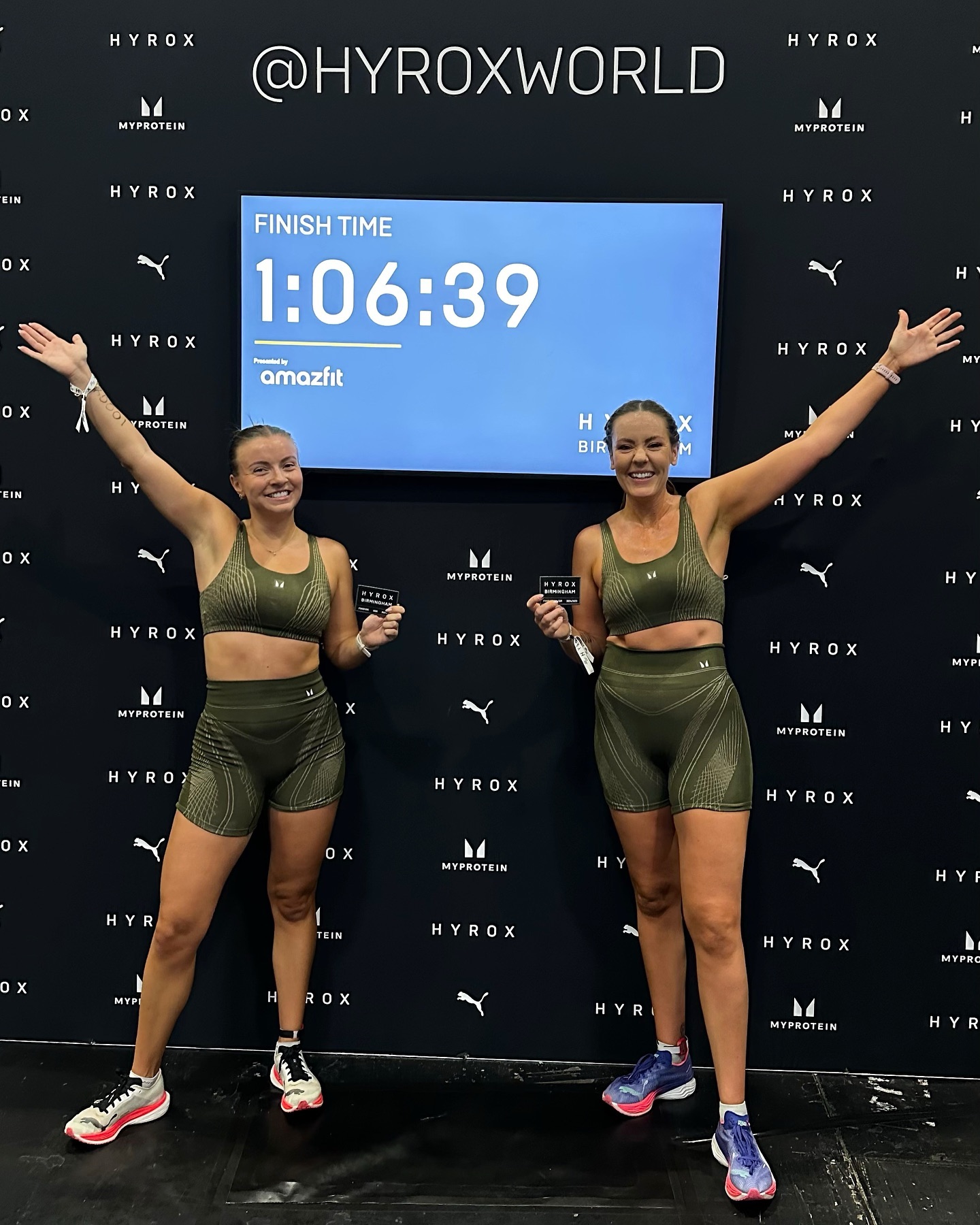 Zoe Rae and Aine Woodman celebrate with their finish time of 1:06:39 at a Hyrox event.