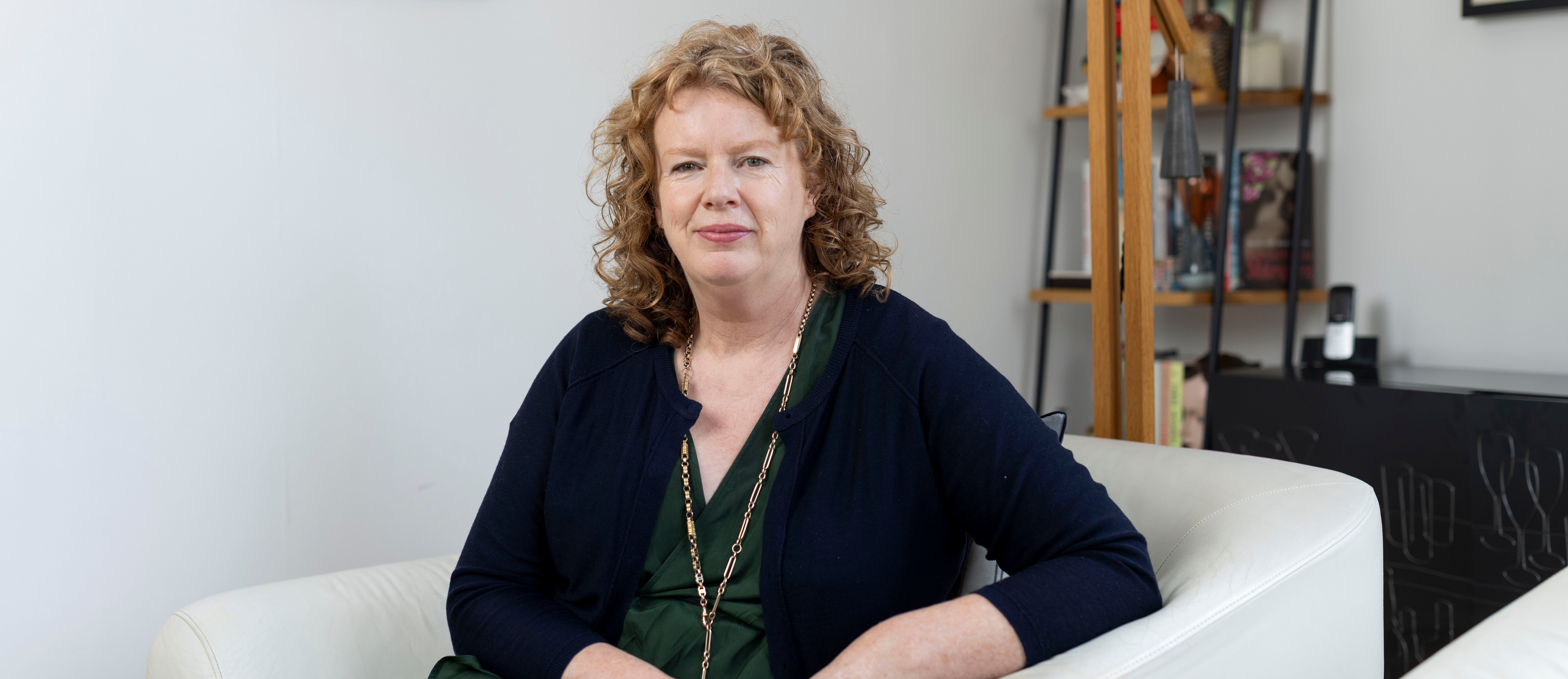 Suzanne O'Sullivan sitting in a white armchair.