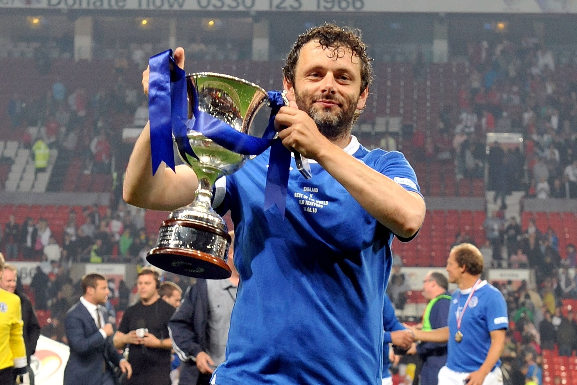 Michael Sheen lifts a trophy for Soccer Aid in aid of UNICEF.