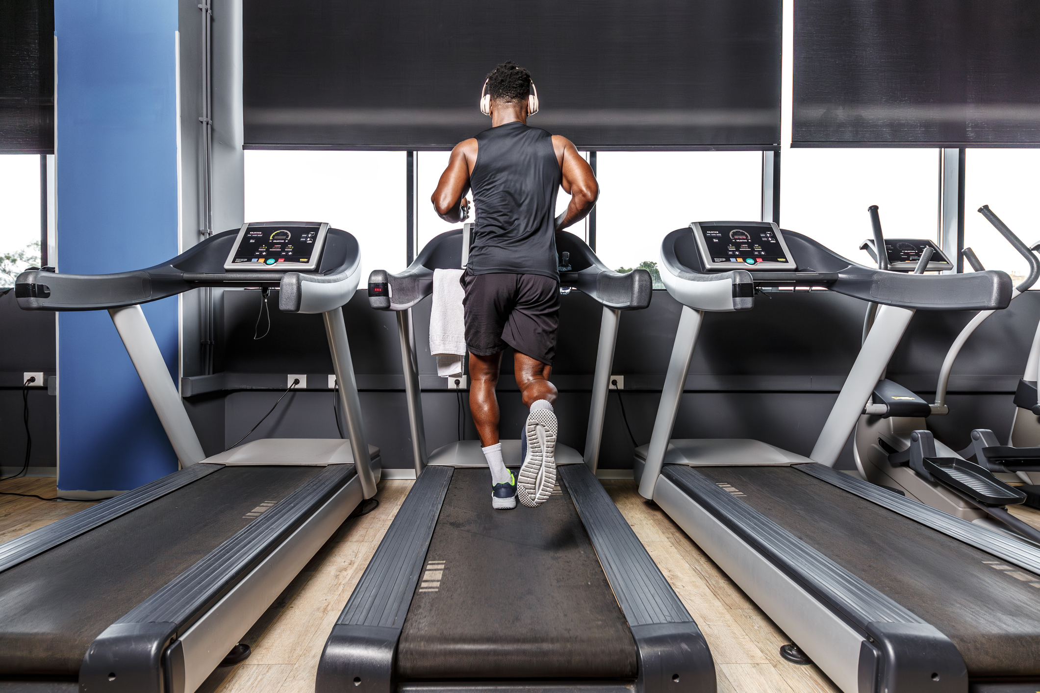 African American male running on a treadmill at the gym.