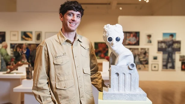 Undated handout photo issued by Arts Council NI of John Rainey at the Ulster Museum Northern Ireland with one of his works