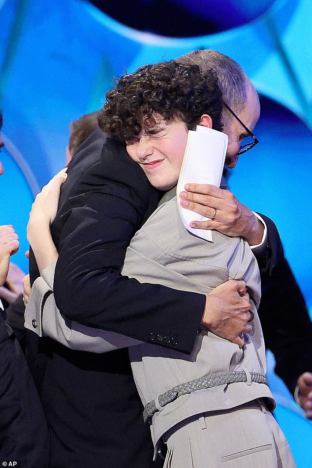 Jack Thorne, left, embracing actor Owen Cooper