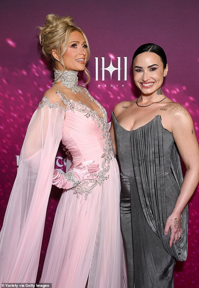 The longtime Hollywood stars wrapped their arms around each other as they flashed their bright smiles under the bright lights and camera flashes