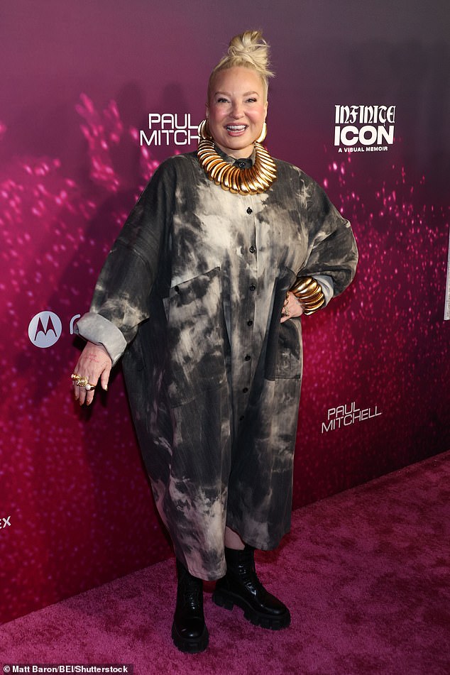 Sia, 50, looked casual-chic in an oversize, distressed button-down dress paired with bold and gold statement jewelry