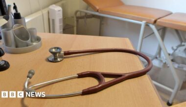 A doctors stethoscope on a table in a GP consultation room