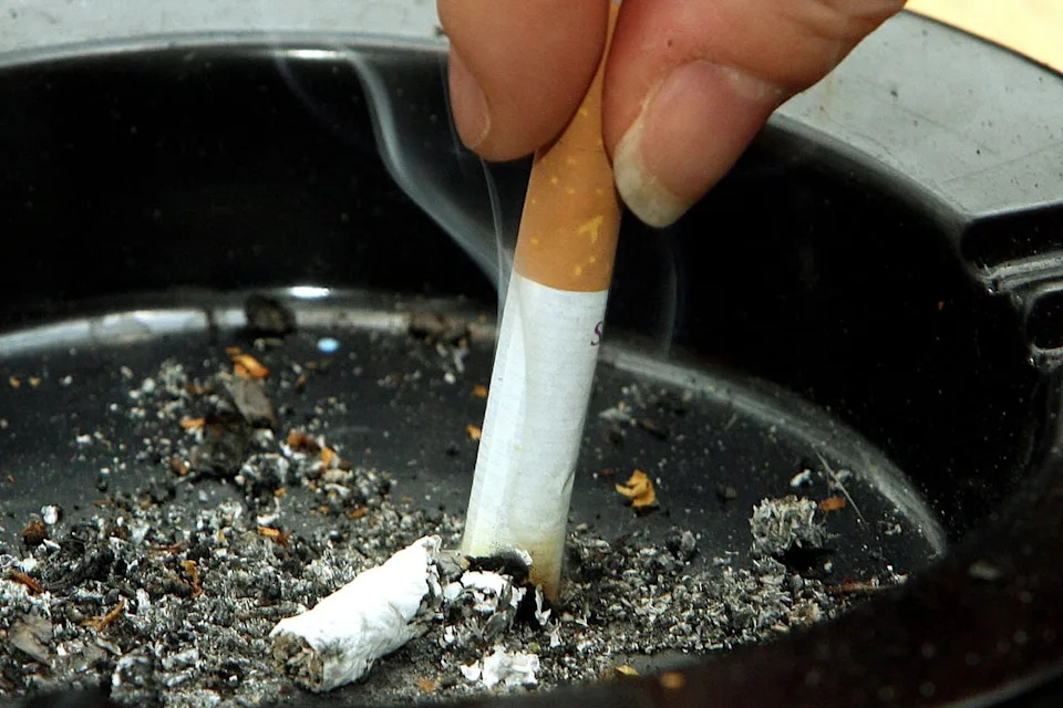 A smoker stubbing out a cigarette in an ashtray (PA) (PA Wire)