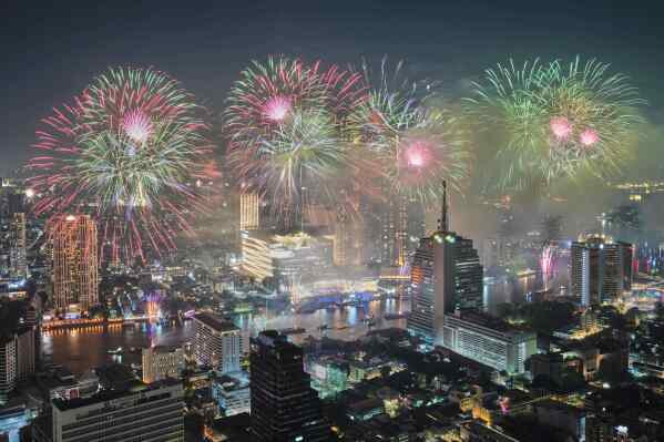 Fireworks explode over Chao Phraya River during New Year celebrations in Bangkok, Thailand, Jan. 1, 2026. (AP Photo/Sakchai Lalit, File)