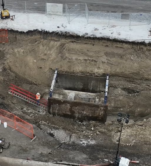 aerial view of repairs on a water main seen dug up and exposed