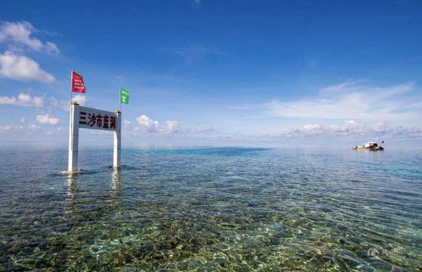 The edge of the blue hole can be seen from a boat