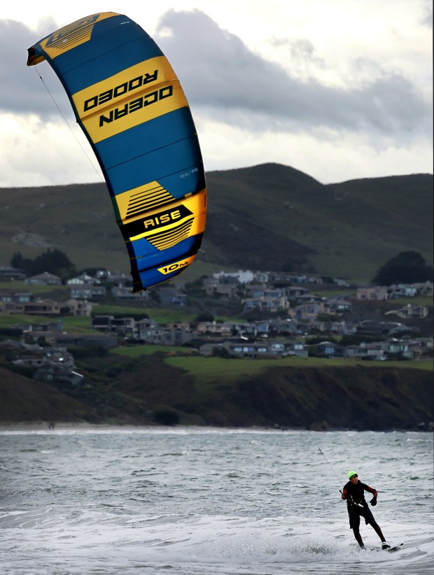 Sam Geller, 70, kite surf s at Doran Regional Park in Bodega Bay, aided by strong winds, an incoming storm and the record breaking king tides, Friday, Jan. 2, 2026. (Kent Porter / The Press Democrat)