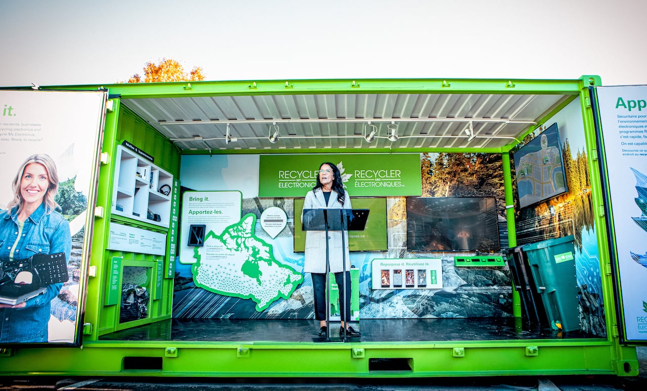 Woman standing at a podium speaking.