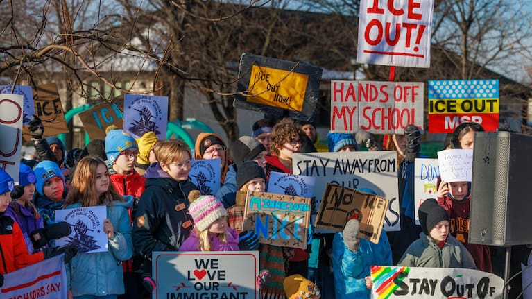 Minneapolis Public Schools families, educators and students hold signs during a news conference at Lake Hiawatha Park in Minneapolis, on Friday, Jan. 9, 2026