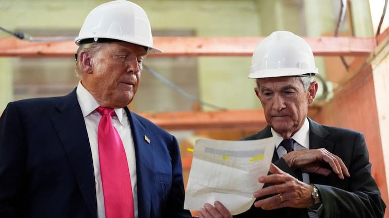Federal Reserve Chairman Jerome Powell, right, and President Donald Trump look over a document of cost figures during a visit to the Federal Reserve.