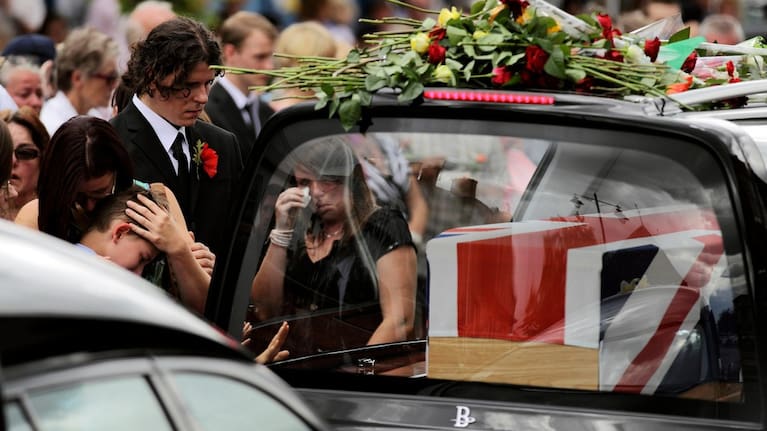 Mourners react as funeral hearses drive the coffins of four British soldiers through the town of Wootton Bassett in England.