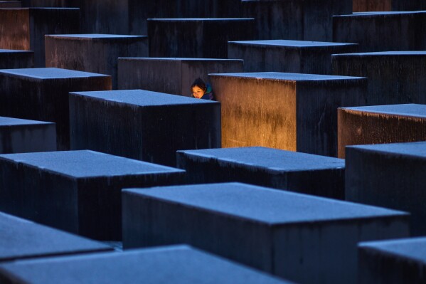 A woman from Hong Kong visits the Holocaust memorial on the eve of the International Holocaust Memorial Day in Berlin, Germany, Monday, Jan. 26, 2026. (AP Photo/Markus Schreiber, File)