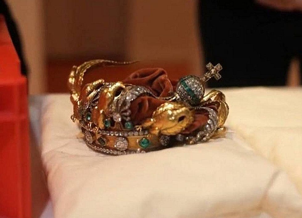 A decorative crown displayed on a soft surface.