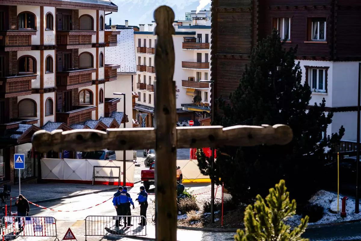 Police officers inspect the area where a fire broke out at the Le Constellation bar and lounge leaving people dead and injured, during New Year’s celebration, in Crans-Montana, Swiss Alps, Switzerland, Thursday, Jan. 1, 2026. (Jean-Christophe Bott/Keystone via AP)