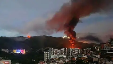 Getty Images Fire at Fuerte Tiuna, Venezuela's largest military complex, is seen from a distance after a series of explosions in Caracas 