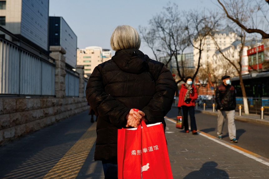 an elderly person with her back turned