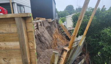 SunLive - Retaining wall crashes on to neighbour's roof